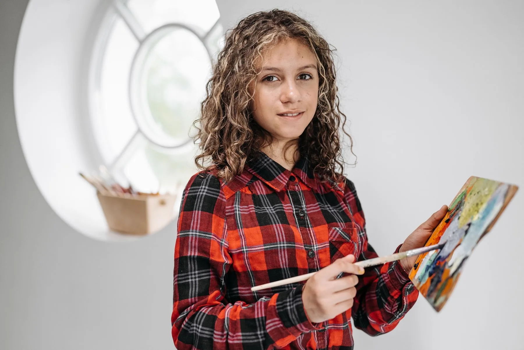 A teen painting at the easel