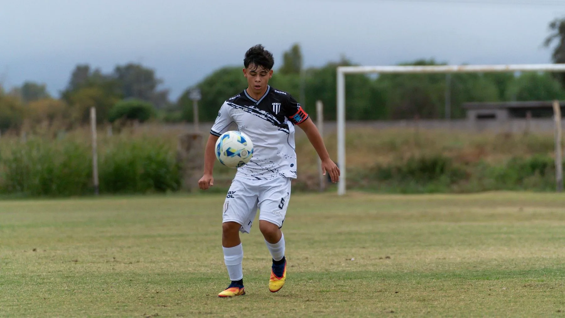A young soccer player controlling the ball
